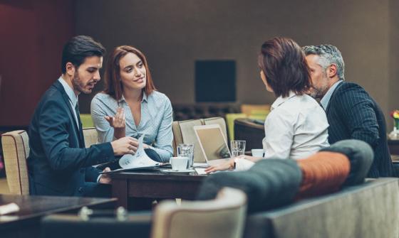 Two women and two men sitting at a boardroom table